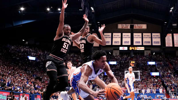 Jan 30, 2024; Lawrence, Kansas, USA; Kansas Jayhawks guard Elmarko Jackson (13) dives for a rebound as Oklahoma State Cowboys guard John-Michael Wright (51) defends during the first half at Allen Fieldhouse. Mandatory Credit: Denny Medley-USA TODAY Sports